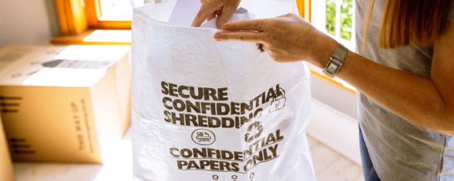 A woman using the shredder bag from Storage King