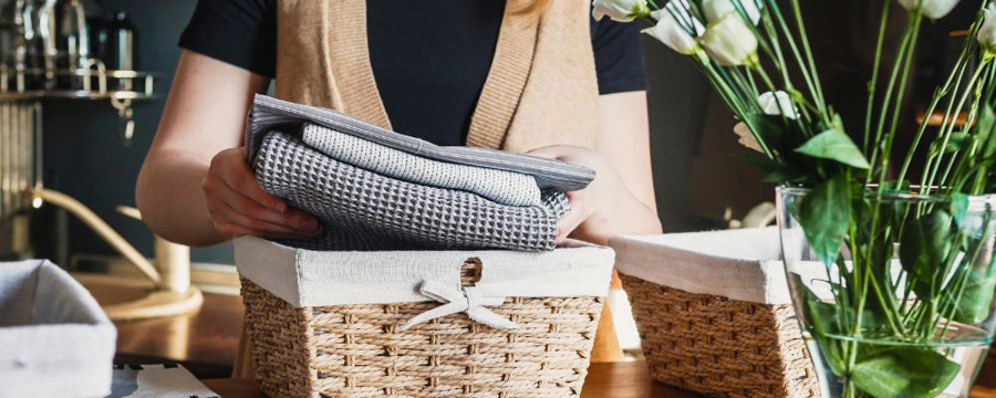 woman-filling-storage-baskets-with linen