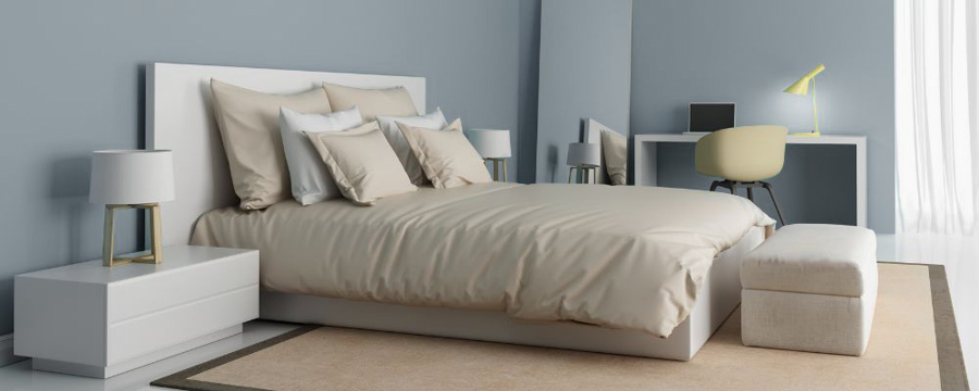 A brightly lit bedroom styled with elevated minimalism elements like light colours and materials