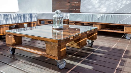 a rustic DIY pallet coffee table in a green room