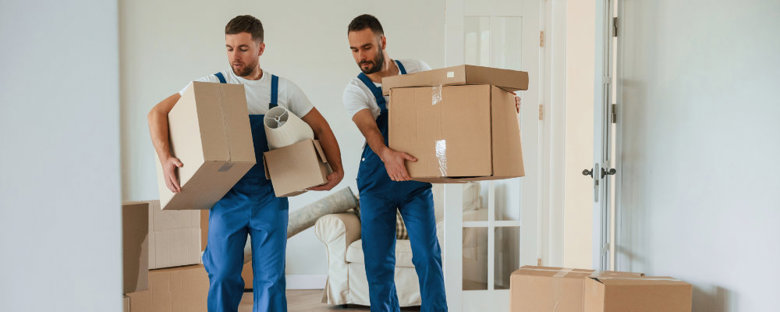 Movers carrying out packed boxes from a home