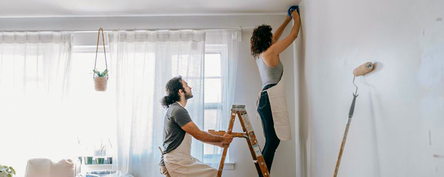 Couple fixing walls when selling their home
