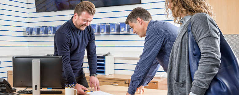 Two short term storage customers signing a contract with a Storage King staff member