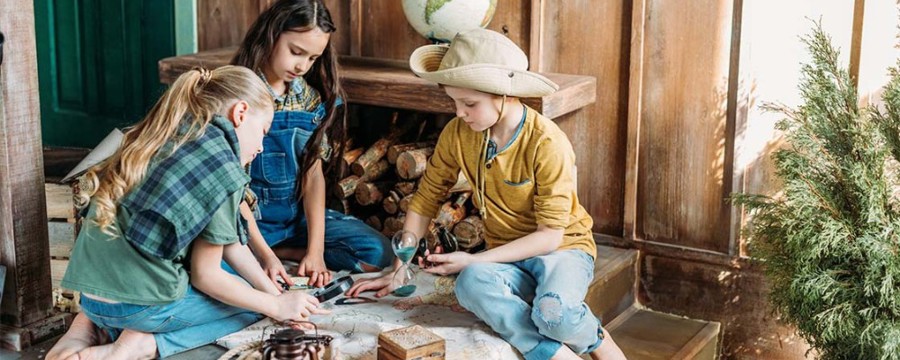 kids go on a treasure hunt in a garden