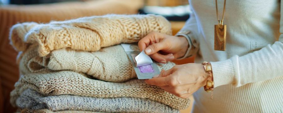 A person inspecting clothes them as they pack