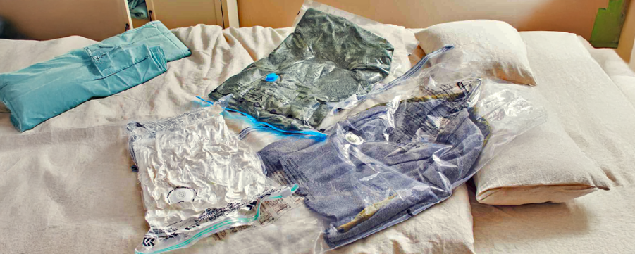 vacuum packed clothes on a bed