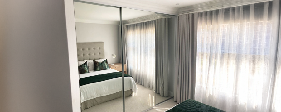 image showing how mirrors can be used to hide a storage space and make a room feel bigger
