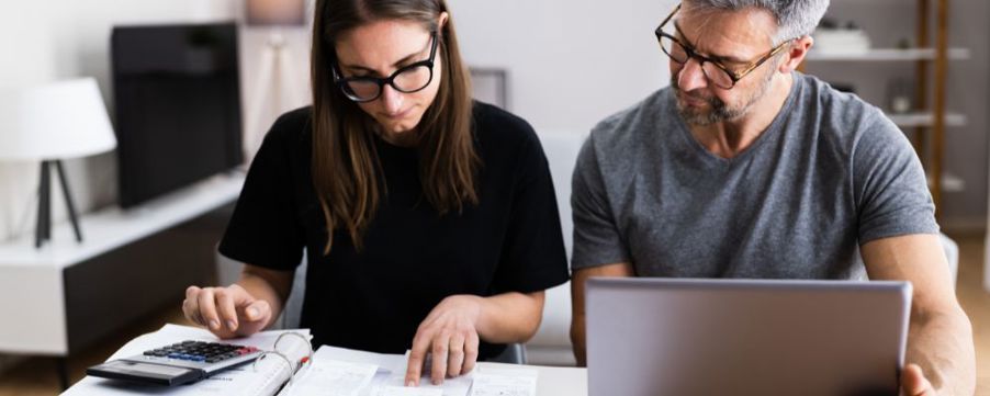 Couple calculating costs of selling home