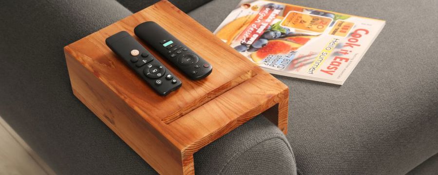 a sofa arm with a compartment for remotes