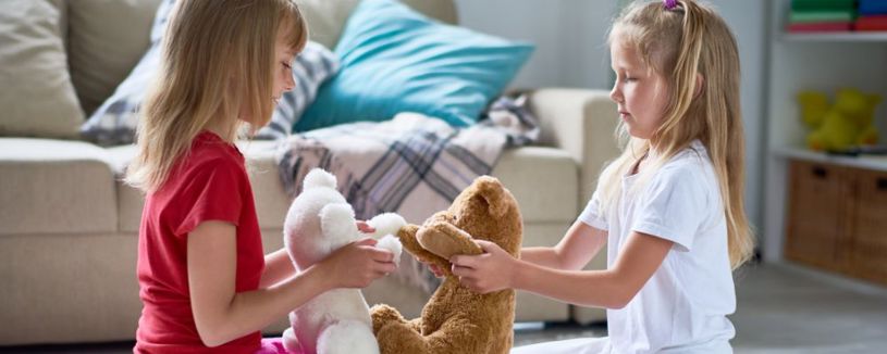 A kid playing with a soft toy