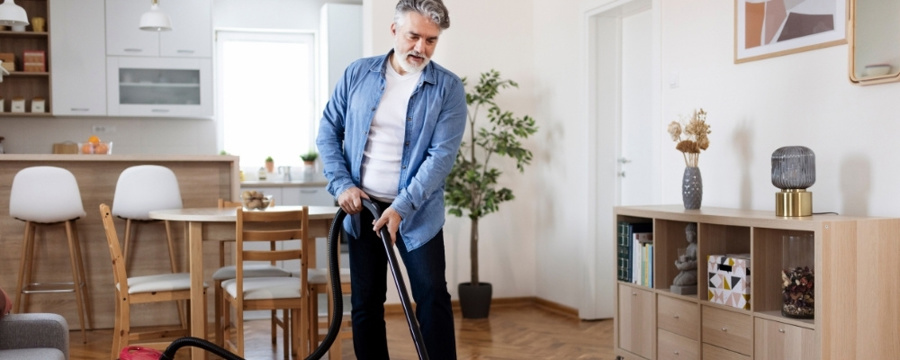 man-cleaning-and-decluttering-his-living-room-in-spring
